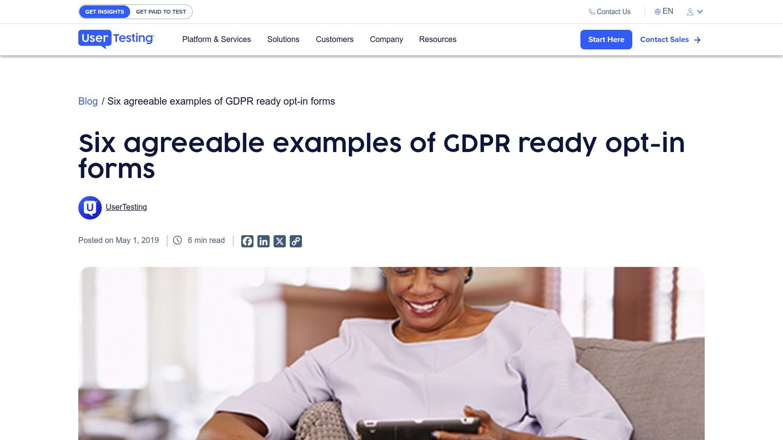 Woman smiling while using a smartphone, illustrating user experience and engagement with GDPR-compliant opt-in forms in email marketing.