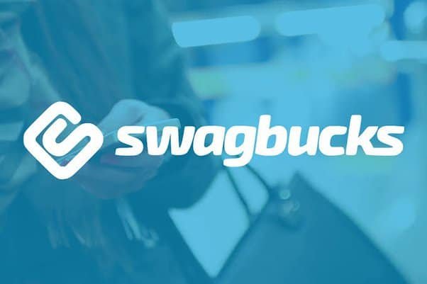 Swagbucks logo overlaying a blurred background of a person holding a smartphone, representing online earning opportunities.