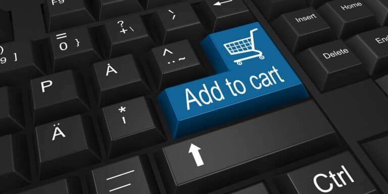 Keyboard key labeled "Add to cart" with shopping cart icon, symbolizing online shopping convenience in tech reviews context.